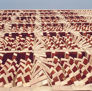 The facade of this building displays twirling stacks of bricks