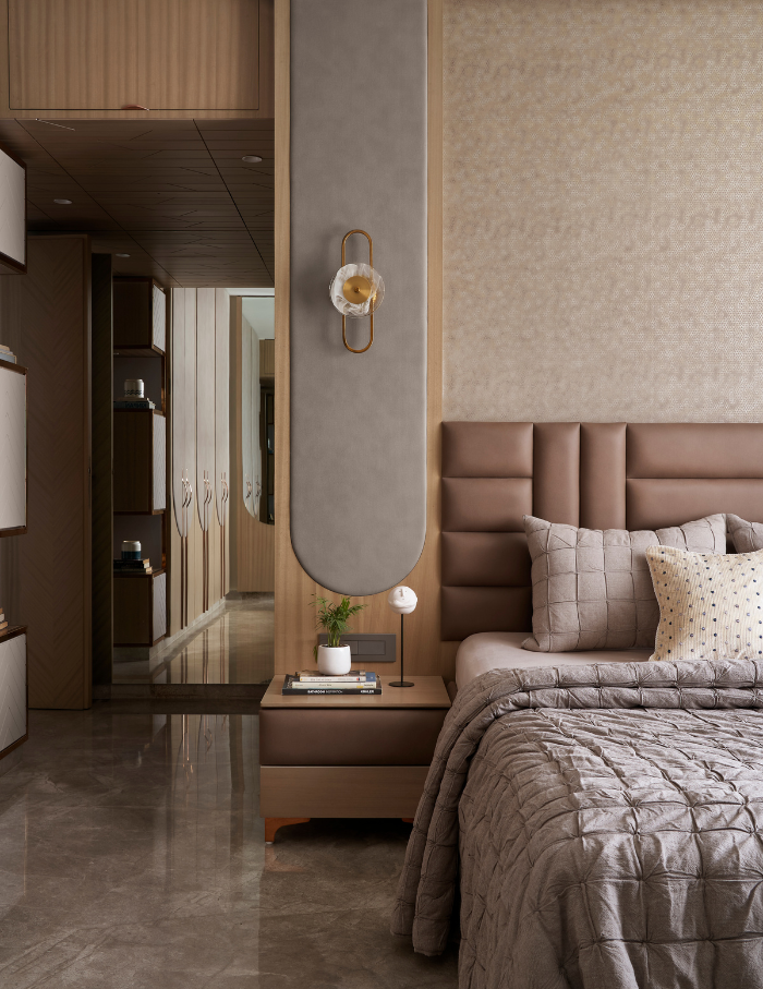 Neutral toned bedroom featuring quilt comforters and textured walls.