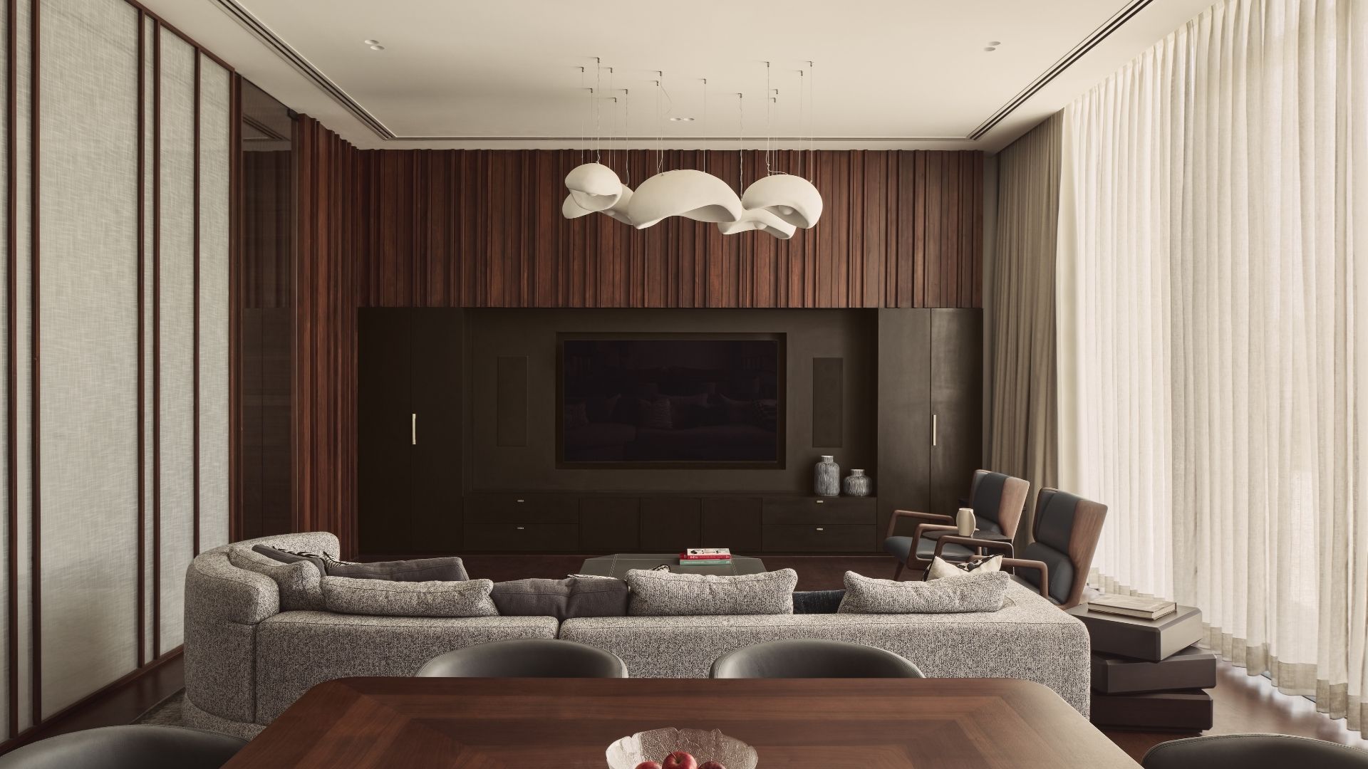 wood walls grey couch sculptural lighting