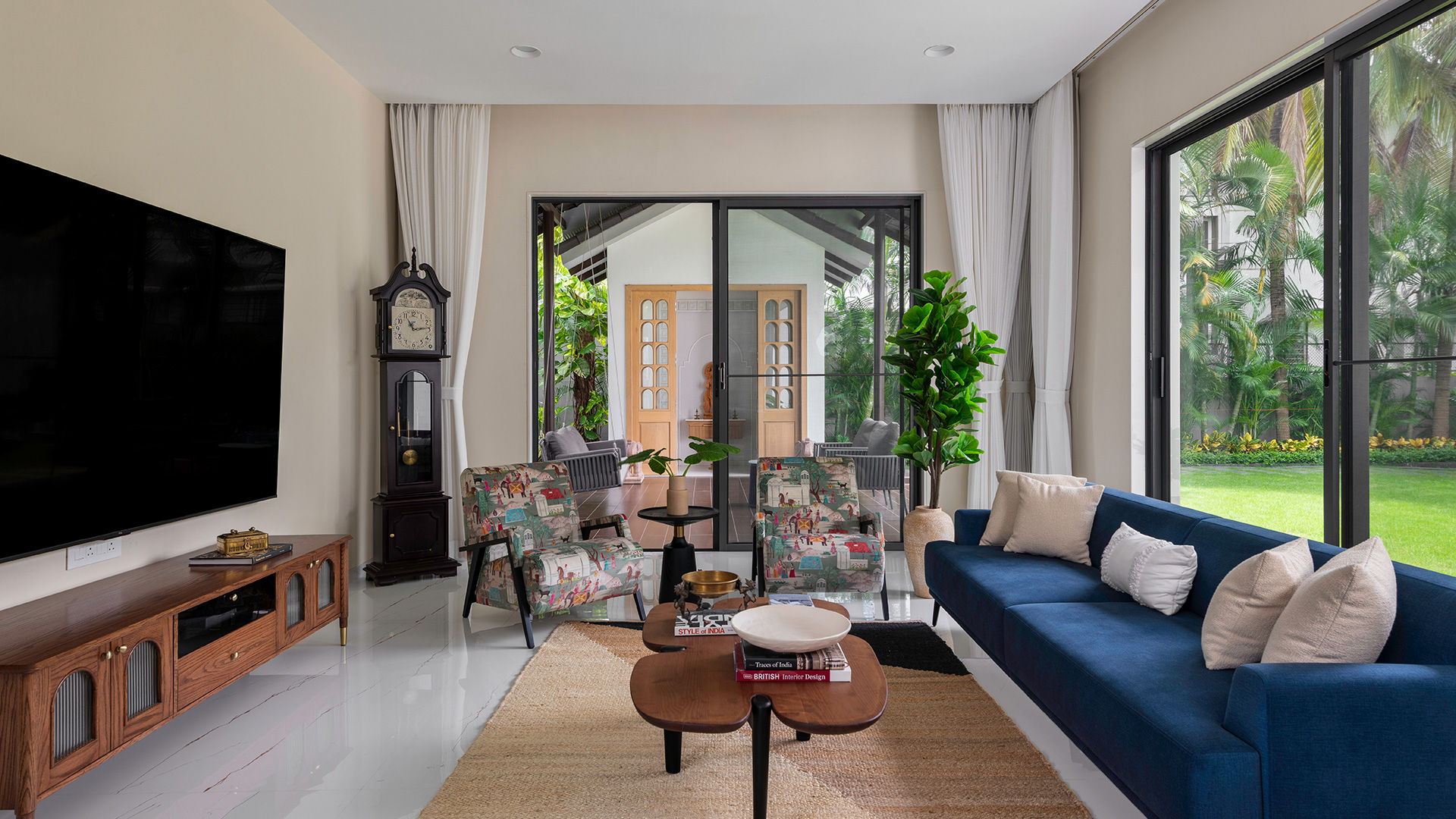 Family area view ith a grandfather clock, navy sofa and glass doors