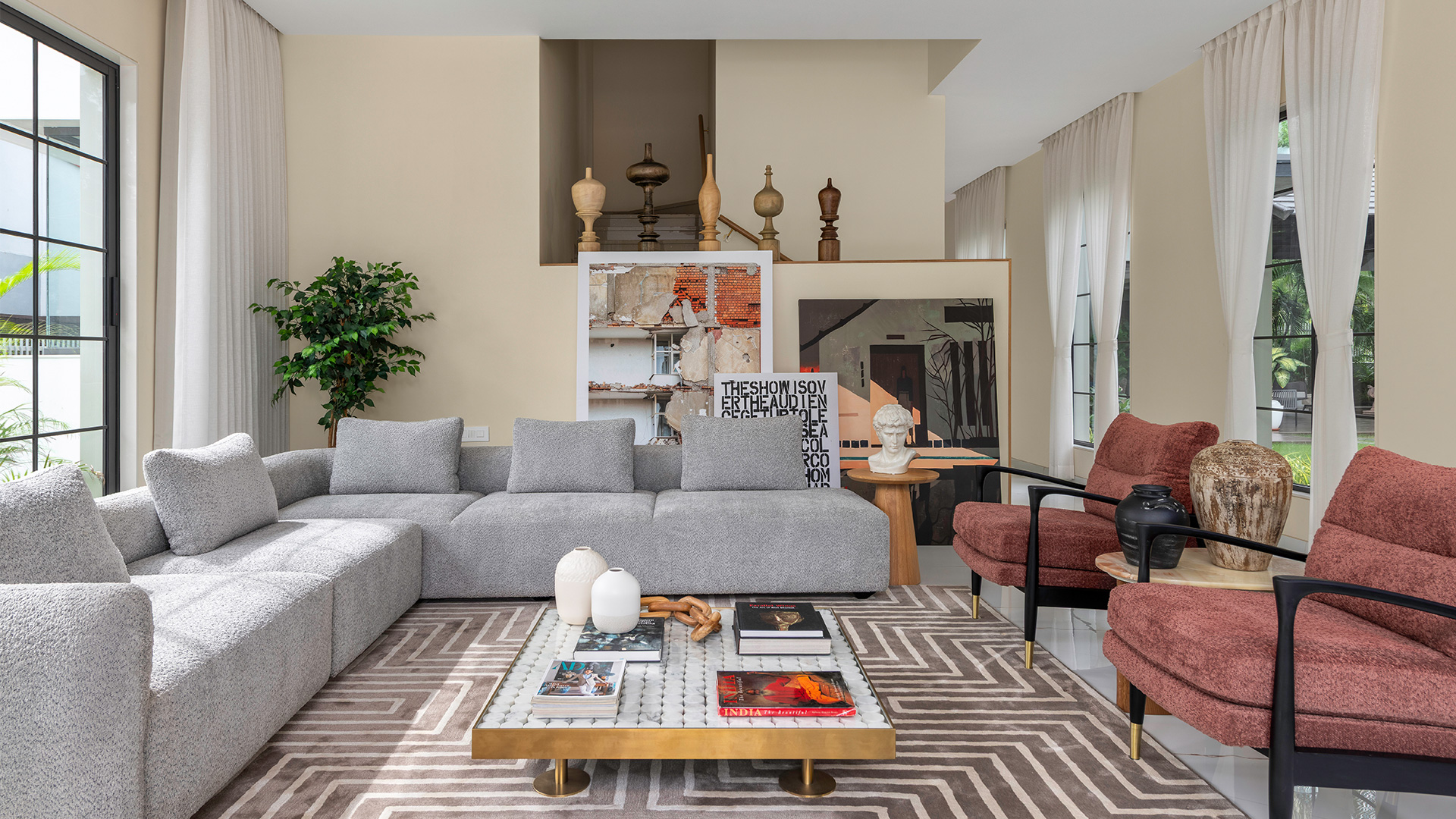 Living room with sculptural accents and a globe chandelier