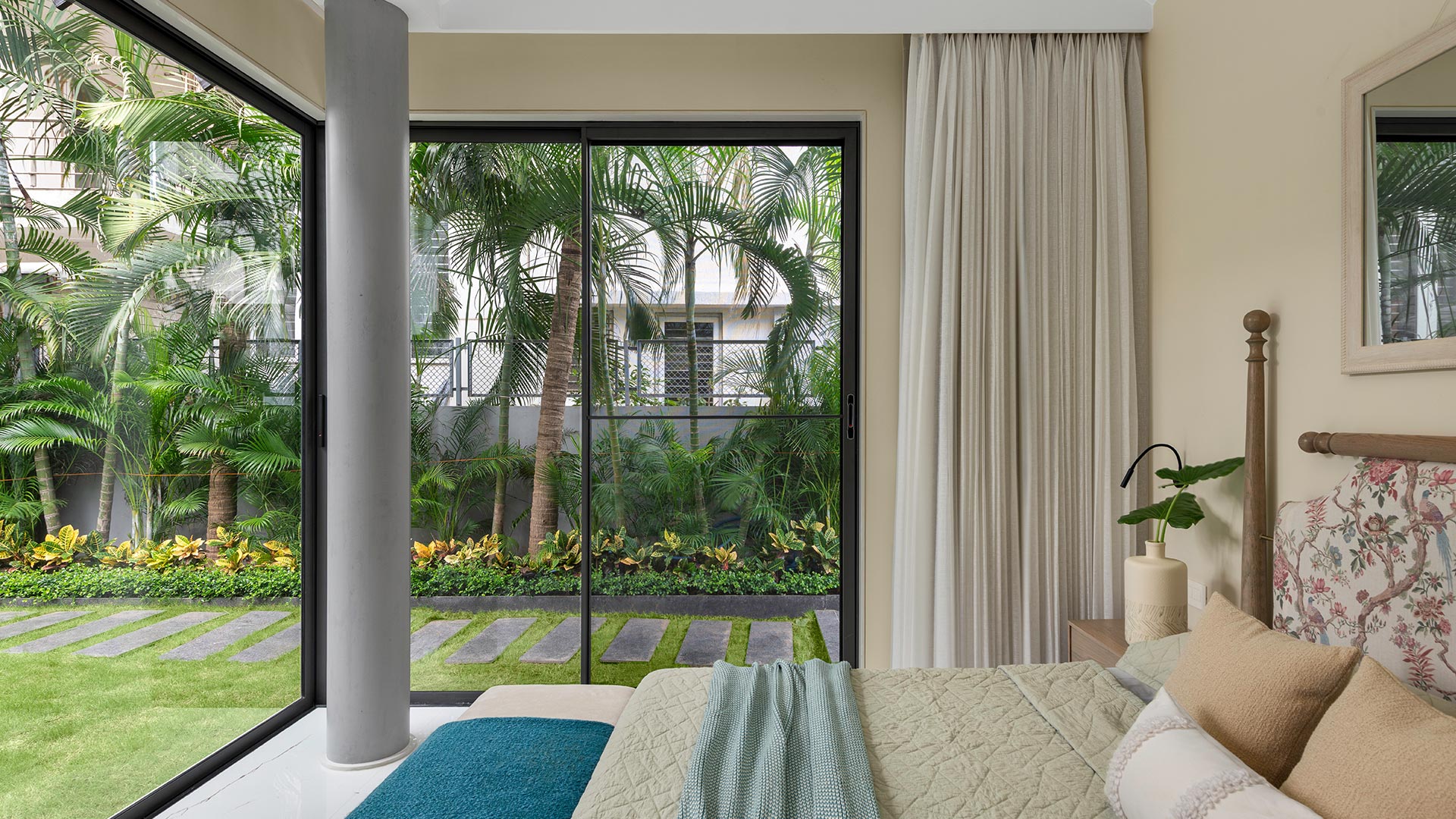Bedroom with big windows and sheer curtains bringing in light