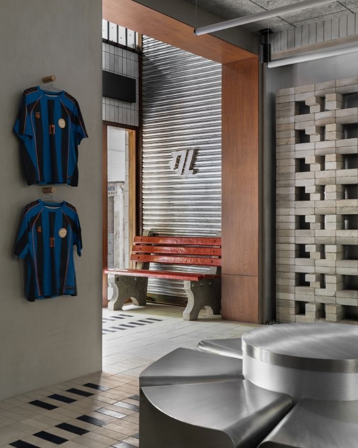 The ground floor of the store is host to a red cement bench with a brand signage by The Knight Designs by Mr Kanwar; Photography by Avesh Gaur