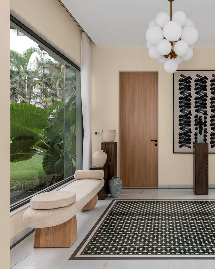 Foyer view with cream hued seating against a picture window