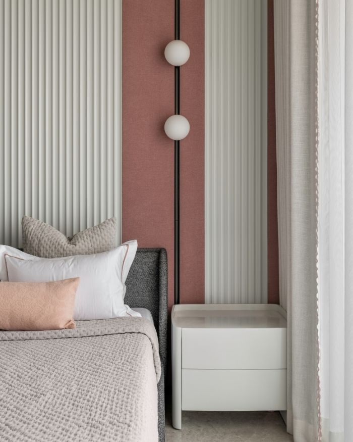 This bedroom features a bed from B&B Italia, with wall track lights from Flos and veneer from Deluxe Veneer; Styled by Sakshi Pathak; Photography by Photographix