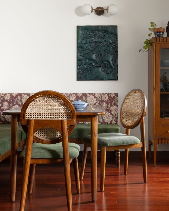 The dining area sees statement chairs from Tusker Katha along with a wall light by Nauticaz; Photography by Roshan Sathish Paliath