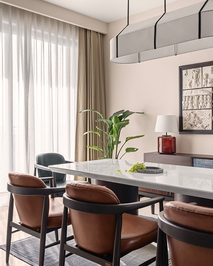 The airy dining space with table and console unit from Unbox Design, leather dining chair and bench from Portside Café; Styled by Styling Abode and Aman Issar; Photography by Tarang Goyal