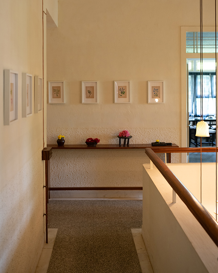 The teak Mahendra Doshi wood console holds earthenware objects found in the antique market lanes of Karaikudi. A medley of miniature paintings by Artist Mohan Prajapati bears the imagery of trees and flowers from the garden; Photography by Hashim Badani
