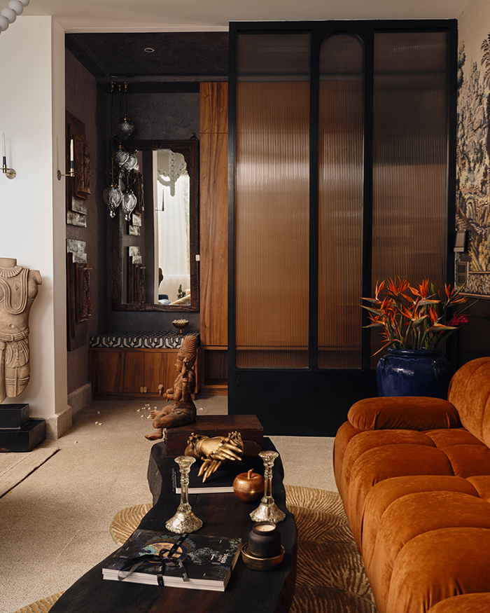 The living room uses a colour palette of warm, earthy hues; Photography by The Matter Studio