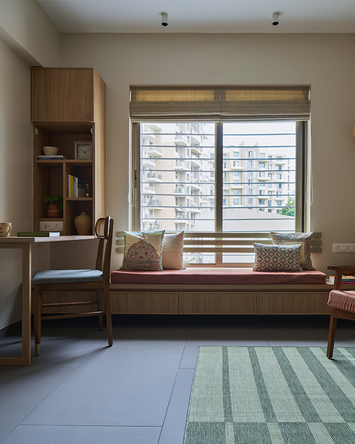 Guest bedroom cum reading corner with window-side seating and cane-backed lounge chairs; Styling by Amol Nalavade; Photography by Manthan Yadav