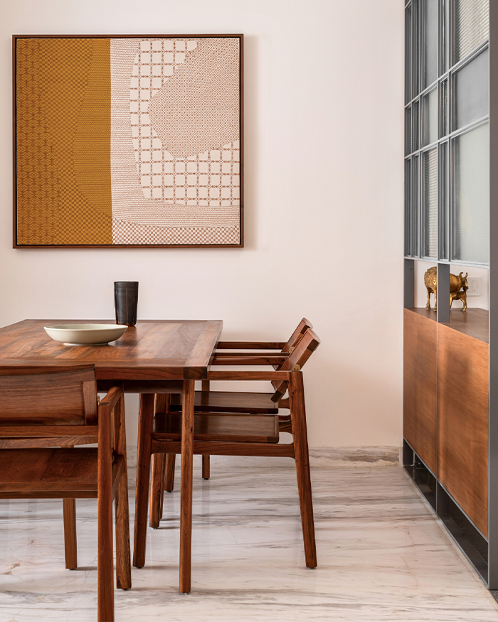 An eight-seater dining table by Vernacular Modern anchors the dining space; Photography by Nayan Soni
