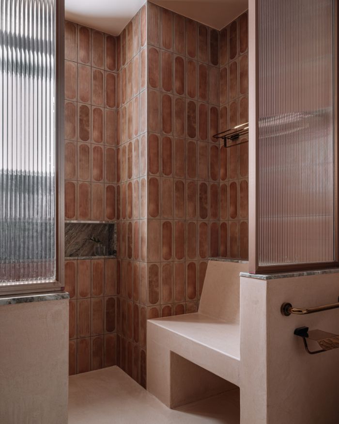 Pastel pinks adorn the bathroom adjoining the grandmother’s
bedroom, containing a small seat for ease of usage; Photography by Ishita Sitwala