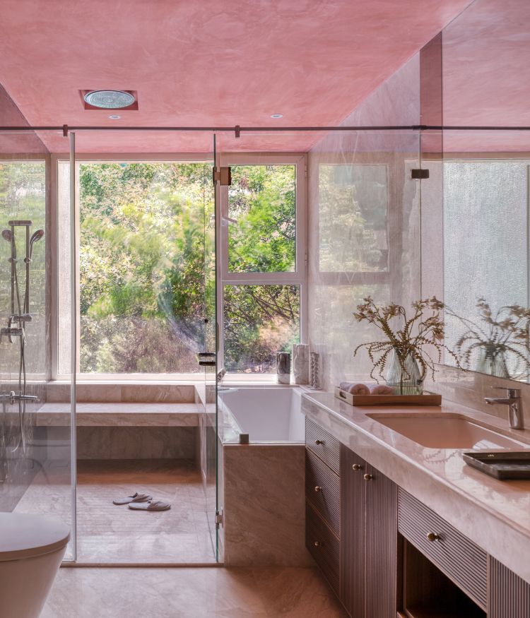 Contemporary bathroom with glass shower enclosure, wooden vanity, pink ceiling, bathtub, and large windows