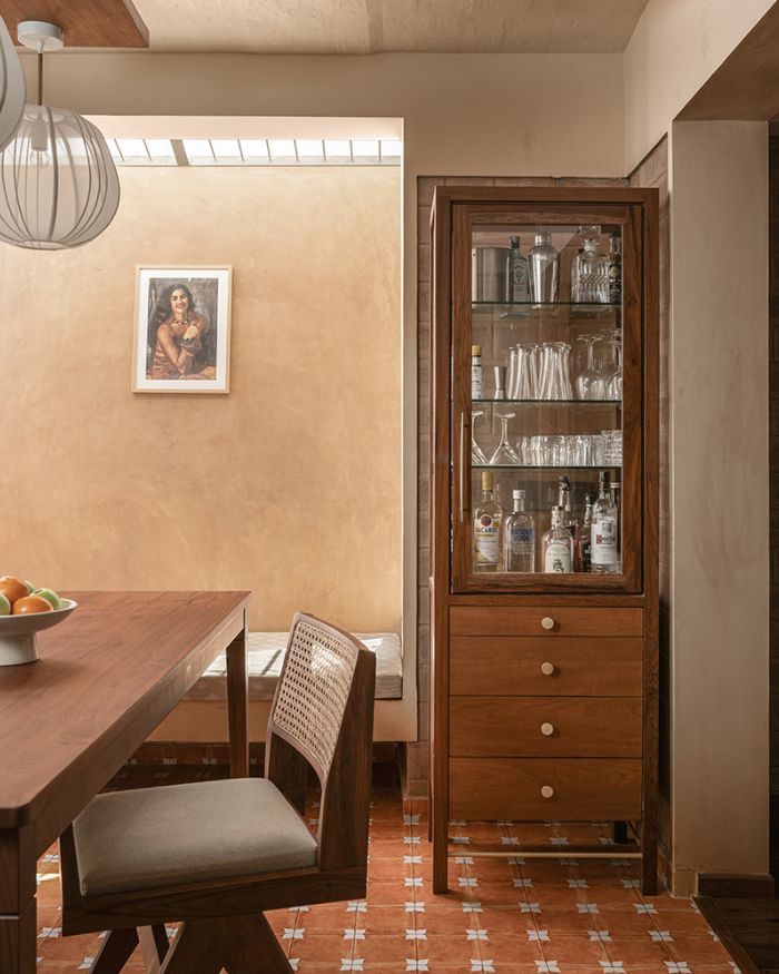 A custom wood cum glass bar cabinet maximises the niche’s modest dimensions; Photography by Nayan Soni