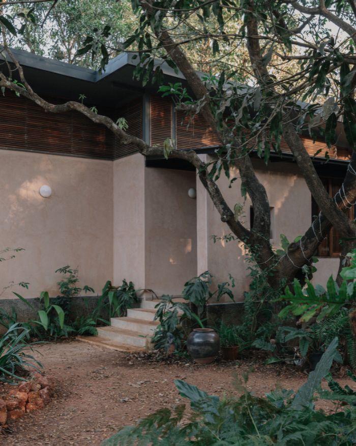 Stone steps rise gently from the earth and lead into the house; Styled by Imran Ali Khan and Rishad Patel; Photography by Shantanu Starick