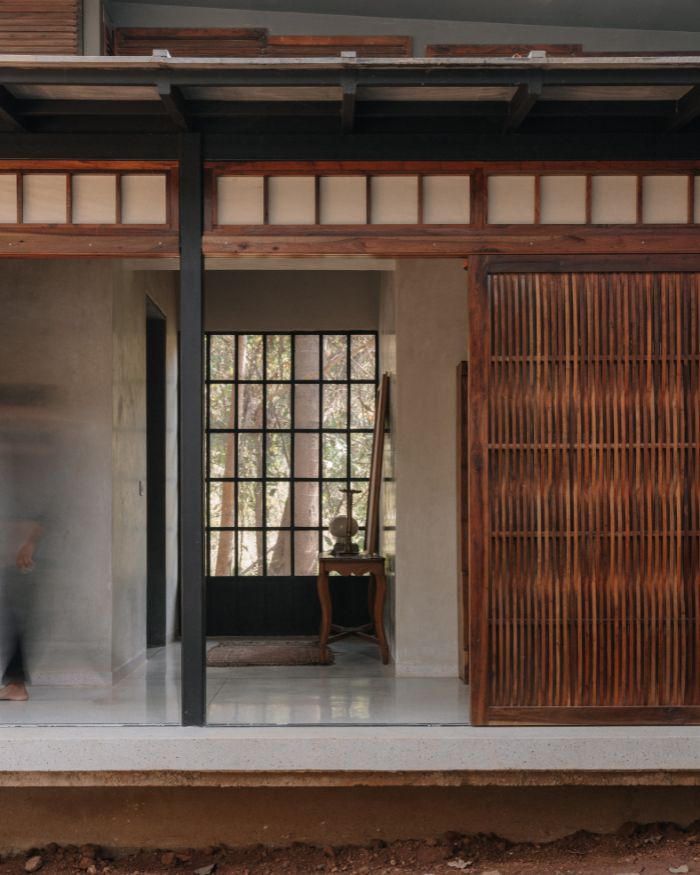 A wooden feature panel stands beside a slender pillar, marking the threshold; Styled by Imran Ali Khan and Rishad Patel; Photography by Shantanu Starick