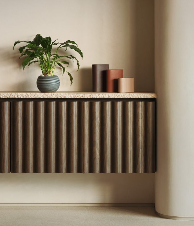 A sculptural console pairs fluted wooden detailing with earthy accents; Photography by Suleiman Merchant