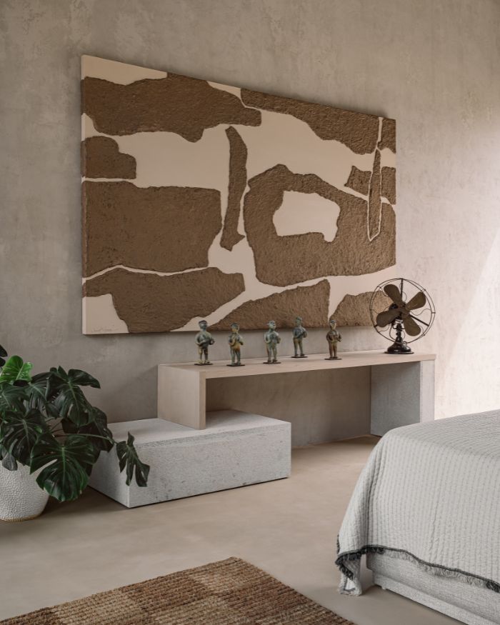 In the bedroom, a solid stone console and a jute rug ground the space; Photography by Ishita Sitwala