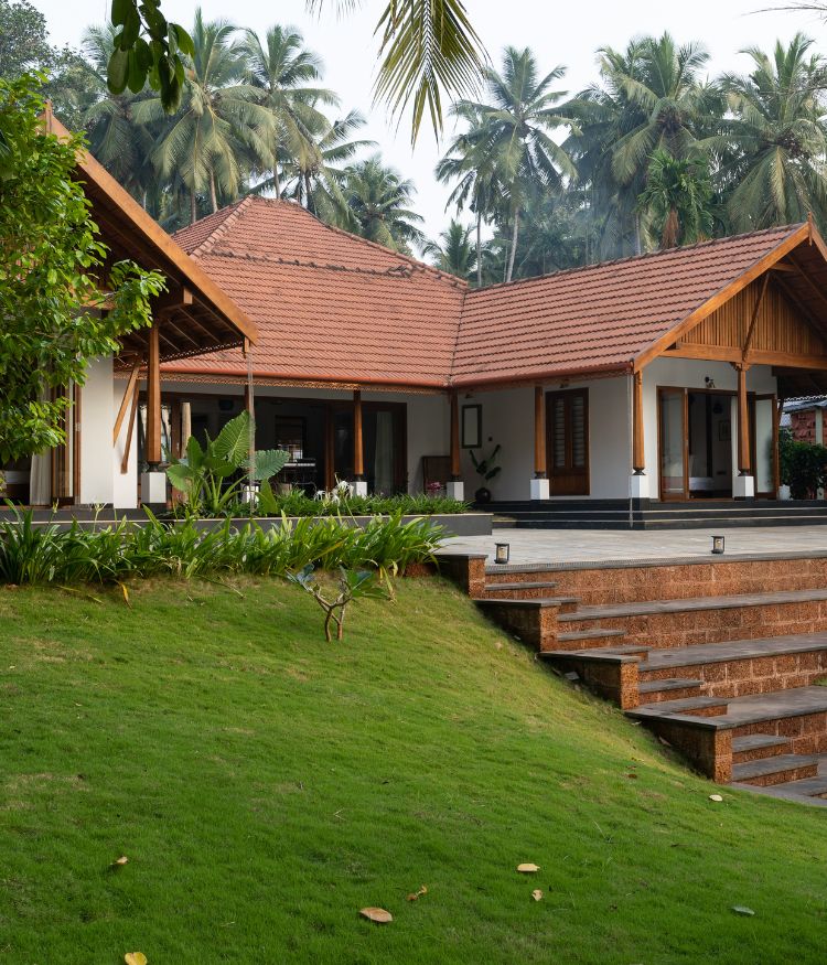 The home appears like an oasis, nestled within a dense embrace of greenery; Photography by Syam Sreesylam