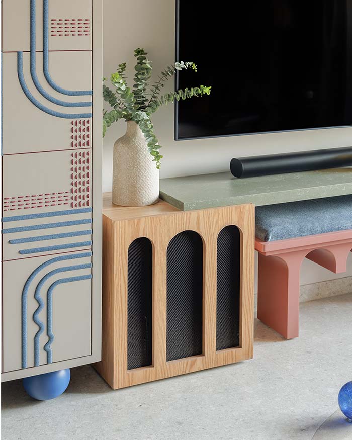 The graphic cabinet, arched console and muted pastels bring crafted whimsy to the media unit. Bar unit designed by Studio Osmosis with Casa Walls and bench and console by Studio Osmosis; Photography by Wabi-Sabi Studio