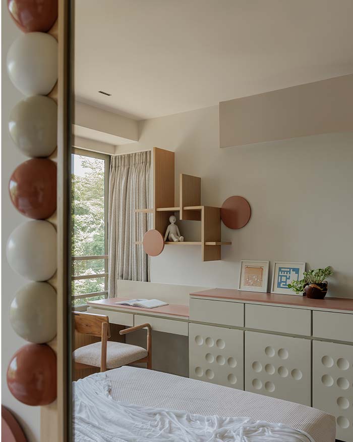 The sunlit bedroom corner pairs playful geometry with neutrals. The custom wall shelf doubles as a sculpture; Photography by Wabi-Sabi Studio