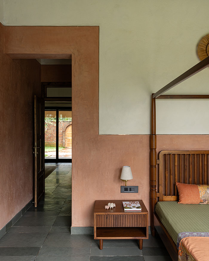 The bedroom features a bed and a side table by Tusker Katha and doors by Dorfen; Photography by Syam Sreesylam