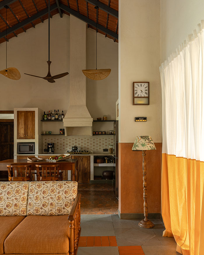 The living area features vintage furniture by Tusker Katha and a rug by Neytt for a relaxed retreat; Photography by Syam Sreesylam