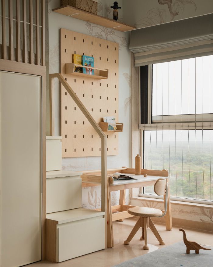 The son’s room spurred creative ingenuity, with Dolce Bambino’s sepia-toned safari wallpaper with soft blues, and a wooden desk-chair by Lila World; Styling by Riddhika Jesrani; Photography by @thekuber @evolve.studio_
