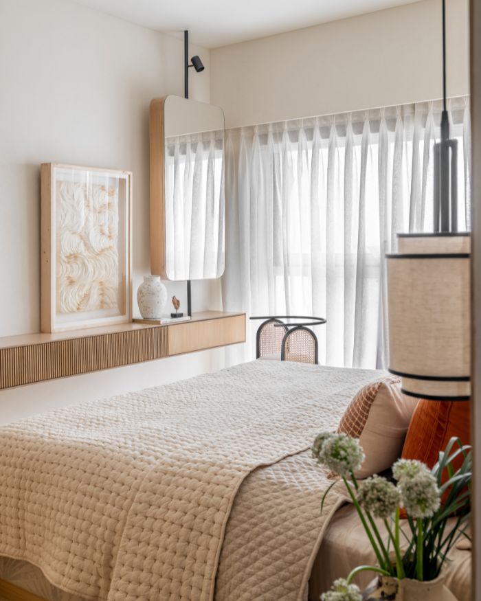 A wall-mounted narrow table runs across the breadth of the sunlit bedroom, complete with a Cultivate Art wall painting and Eeshaan Kashyap tablescaping; Styling by Riddhika Jesrani; Photography by @thekuber @evolve.studio_