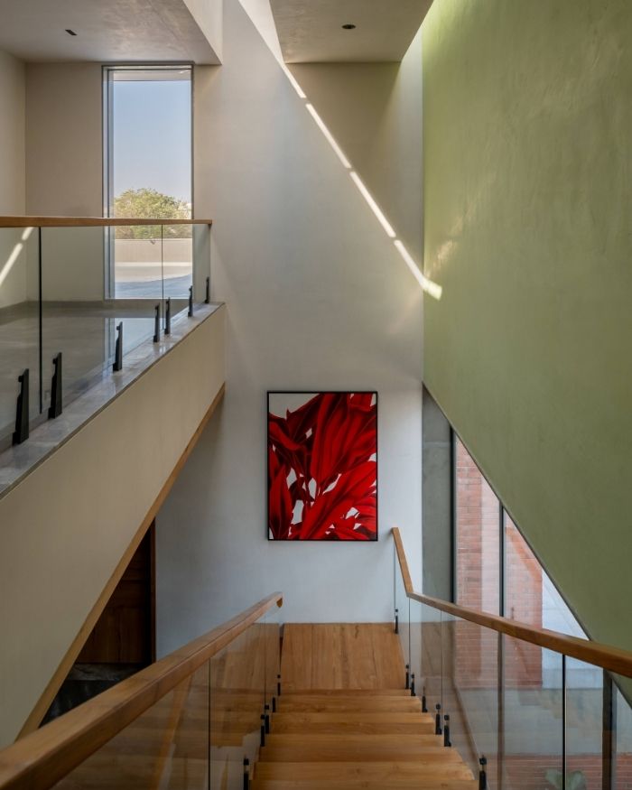Glass-lined perforations in the stairwell’s ceiling draw light into the home’s spine; Styled by Saniya Tadha, Photography by Vinay Panjwani