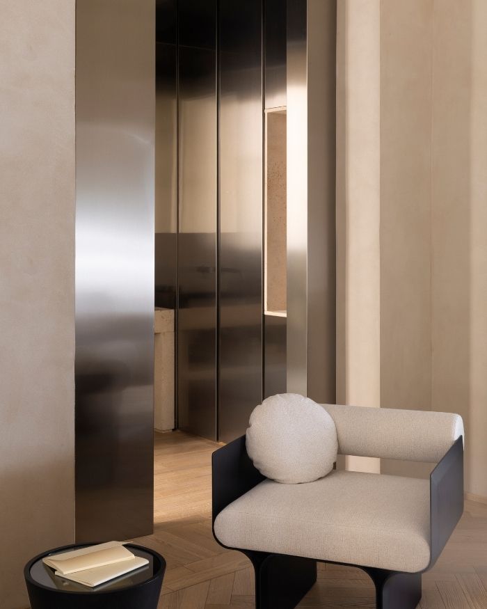 The use of metallic finishes lends a contemporary edge to the room, their muted lustre balancing the tactile richness of the surrounding natural materials; Photography by Serena Eller of Eller Studio