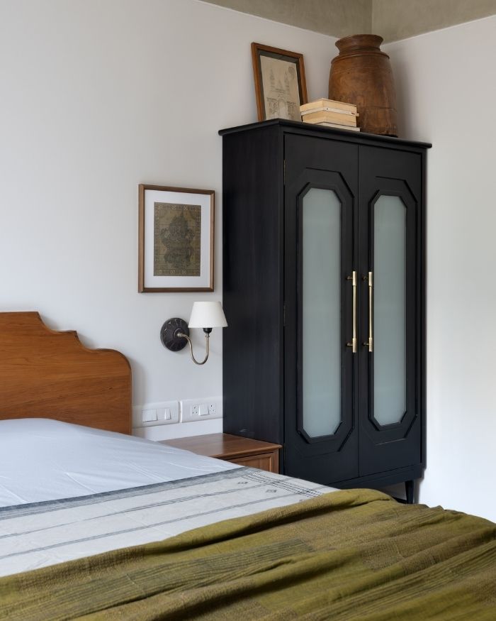 A play of contrast defines this corner, where crisp walls meet dark cabinetry and warm timber; Photography by Hemant Patil