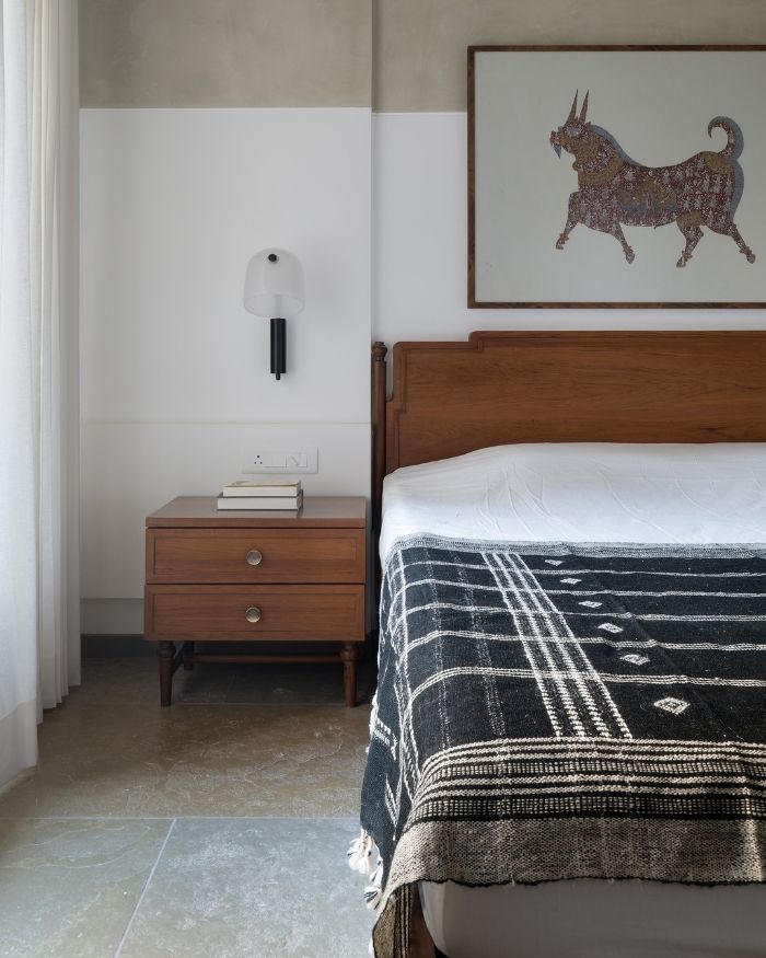 Layered with natural materials and handcrafted details, the bedroom balances warmth and simplicity through custom-designed timber furniture and artisanal decor; Photography by Hemant Patil