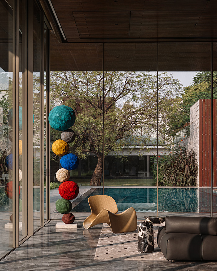A centre table from Roche Bobois, a lounger by andblack and a sofa by Roche Bobois decorate the interiors. A vibrant
sculpture by Annie Morris adds vivacity to the austere space; Photography by Ishita Sitwala