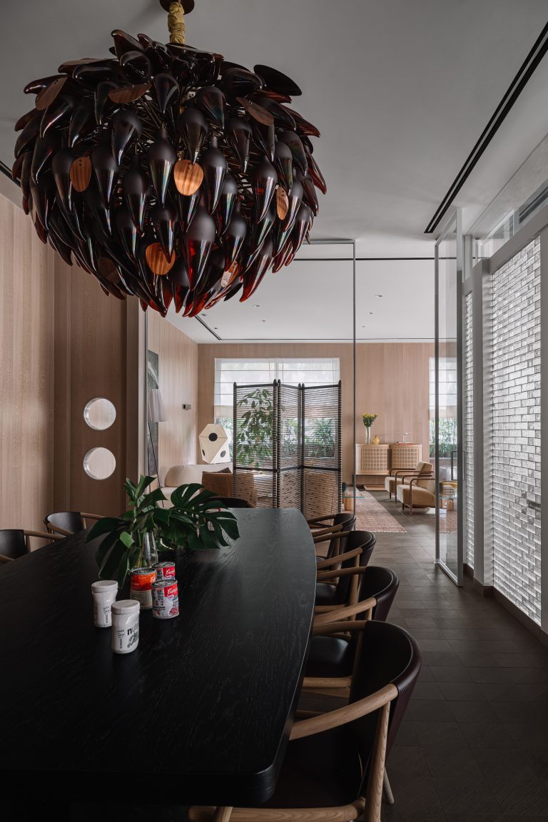 Ceramic and embroidered fabric jars by Mahbubur Rahman form the centrepiece atop a DeMuro Das dining table with noir finish base. A deep burgundy chandelier by Klove had its colour specifically customised for this project, a nod to Iram and Gautam's love for wine. The chairs are by B&B Italia;