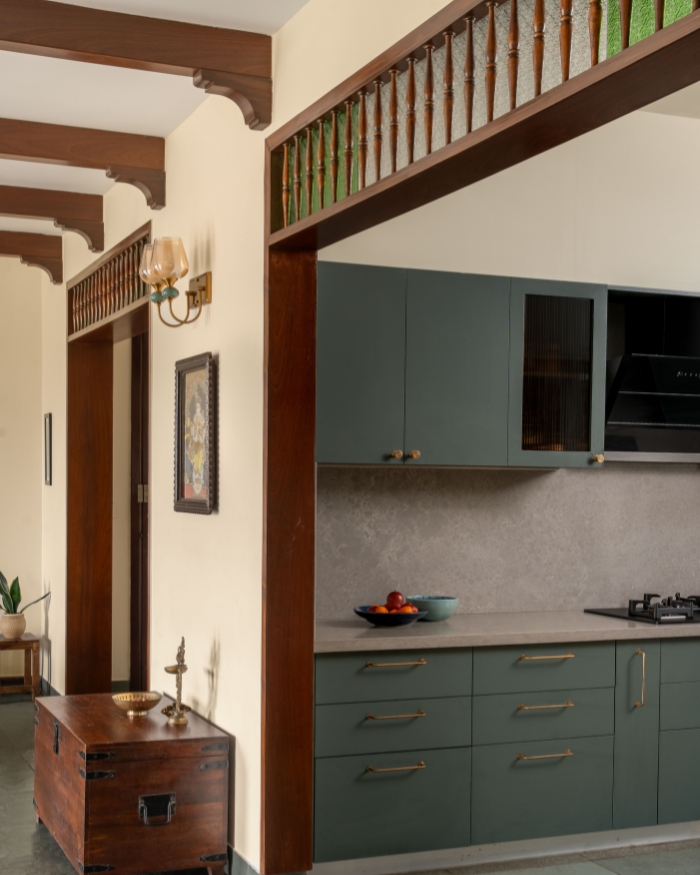 The deep green hue of the millwork is a fitting contrast to the sea of grey across the flooring, countertop and backsplash; Photography by Shine Parsana