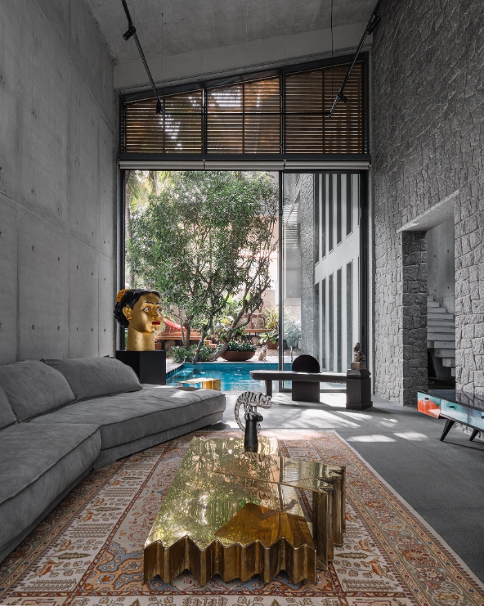 A gilded Ravinder Reddy sculpture dominates a corner of the living room, its gleam rivalled by the flamboyant Henge centre table. The warm hues of the rug by Carpet Cellar score a striking presence, accentuated by the grey Baxter sofa, the bench by Atelier Ashiesh Shah and the side table designed by the couple’s studio Onedot6; Photography by Ishita Sitwala