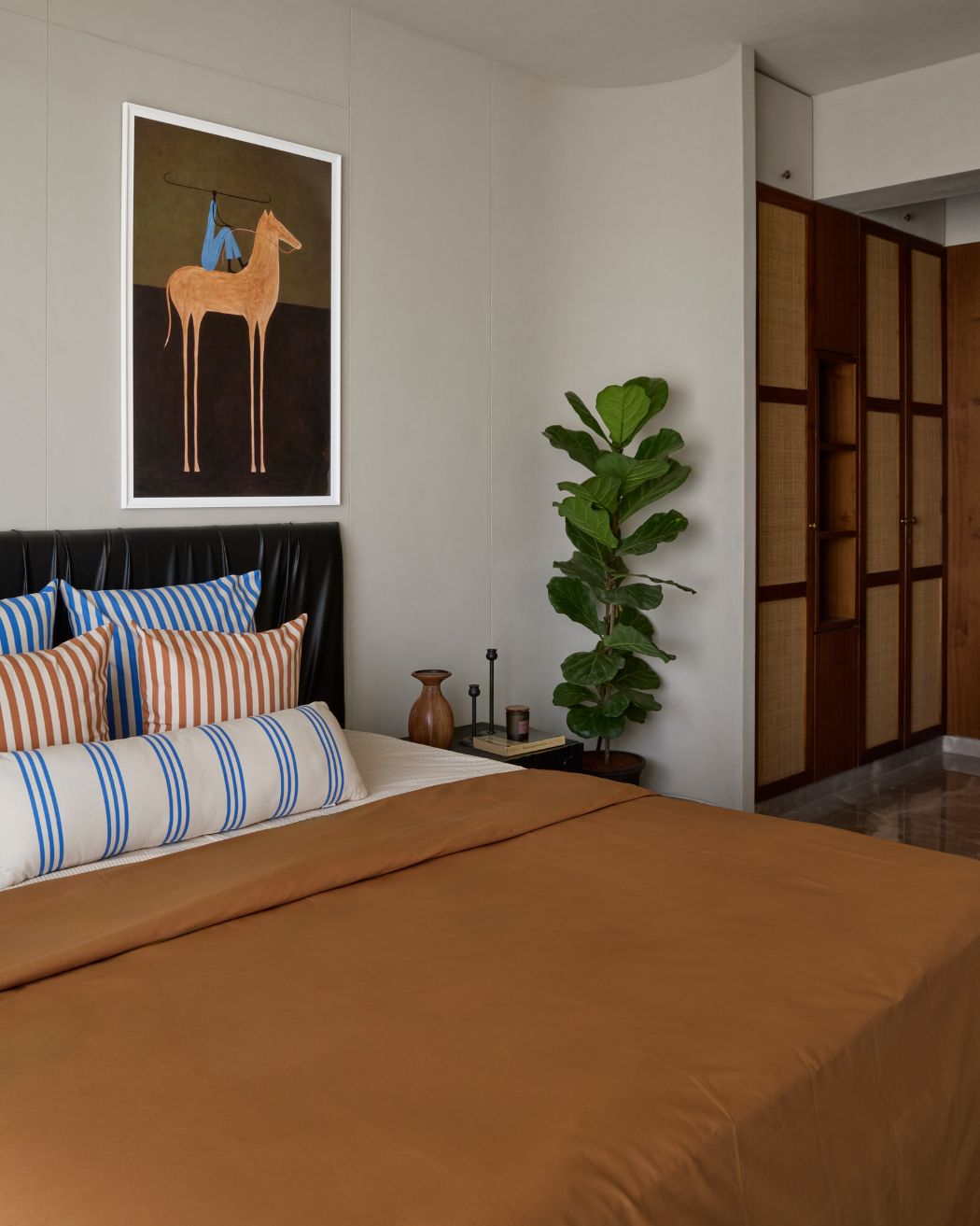 The beige paneled plaster walls showcase curved corners which creates an entryway to the built-in wardrobe corridor. Styled by Namrataa Shetty; Photography by Talib Chitalwala