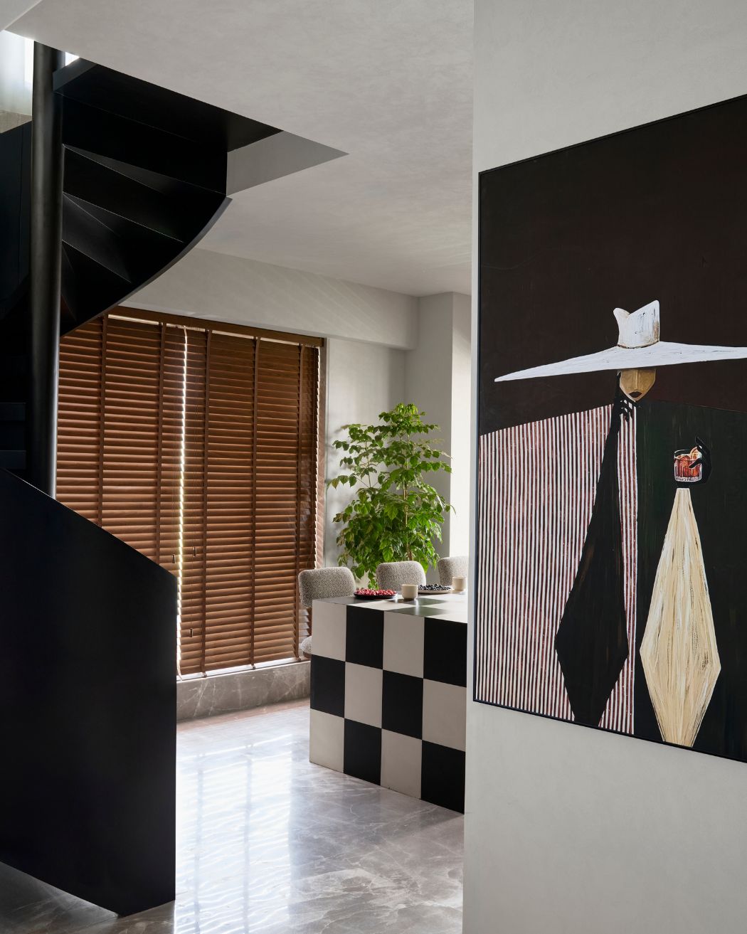 The kitchen features a cooking station and dining counter with checkered patterns paired with tweed wood stools. Styled by Namrataa Shetty; Photography by Talib Chitalwala