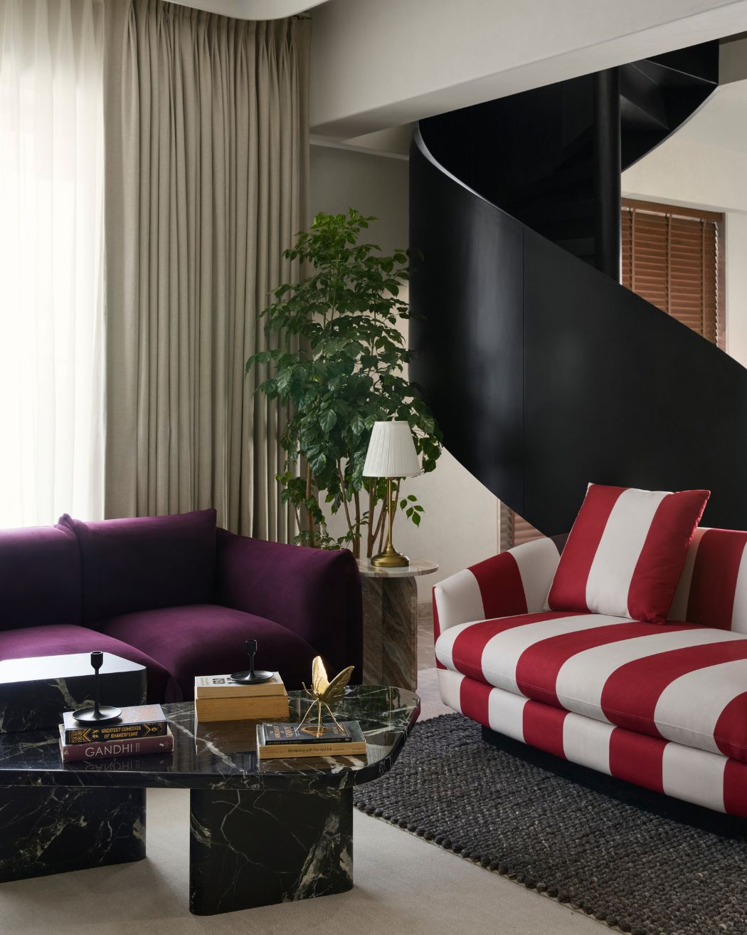 In the living room, the lush sofas are accompanied by Rosso Levanto marble side tables with props and accessories from H&M home. Styled by Namrataa Shetty; Photography by Talib Chitalwala