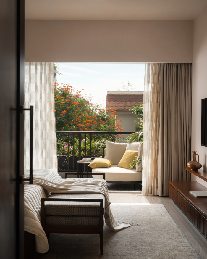 A sleek chair from Essentially Metal frames a cosy, inviting corner in the balcony; Styling by Apoorva Nayak, Photography by Arjun Krishna