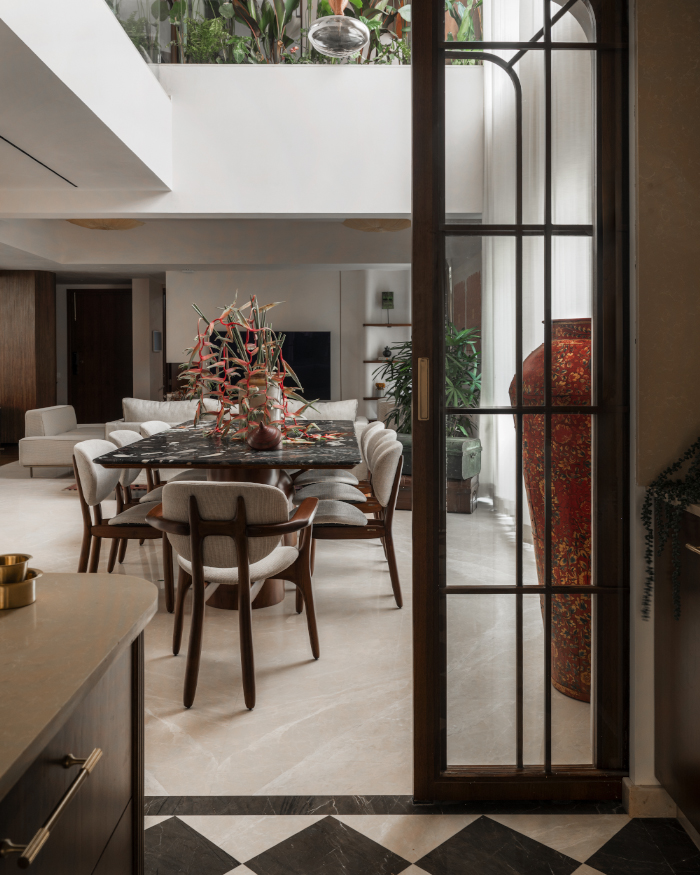 Tramo chair from Magari grounds the dining space, while a bespoke red vase from Curious Hues introduces an artistic contrast; Styling by Apoorva Nayak, Photography by Arjun Krishna