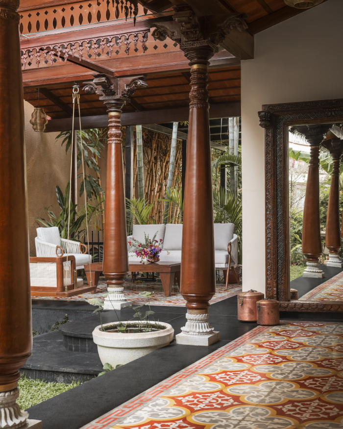 Traditional Karekudi pillars, Athangudi Palace Tiles flooring and Beruru lights meet contemporary accents of a mirror from Studio Palash and furniture by Essentially Metal to create a soul-filled courtyard; Styling by Apoorva Nayak, Photography by Arjun Krishna