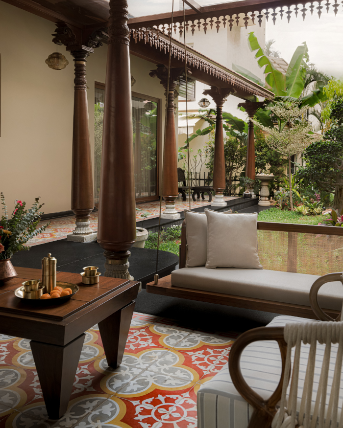 Round cut lights from Beruru highlight Athangudi Palace Tiles flooring and traditional Karekudi pillars along a statement swing from Essentially Metal; Styling by Apoorva Nayak, Photography by Arjun Krishna