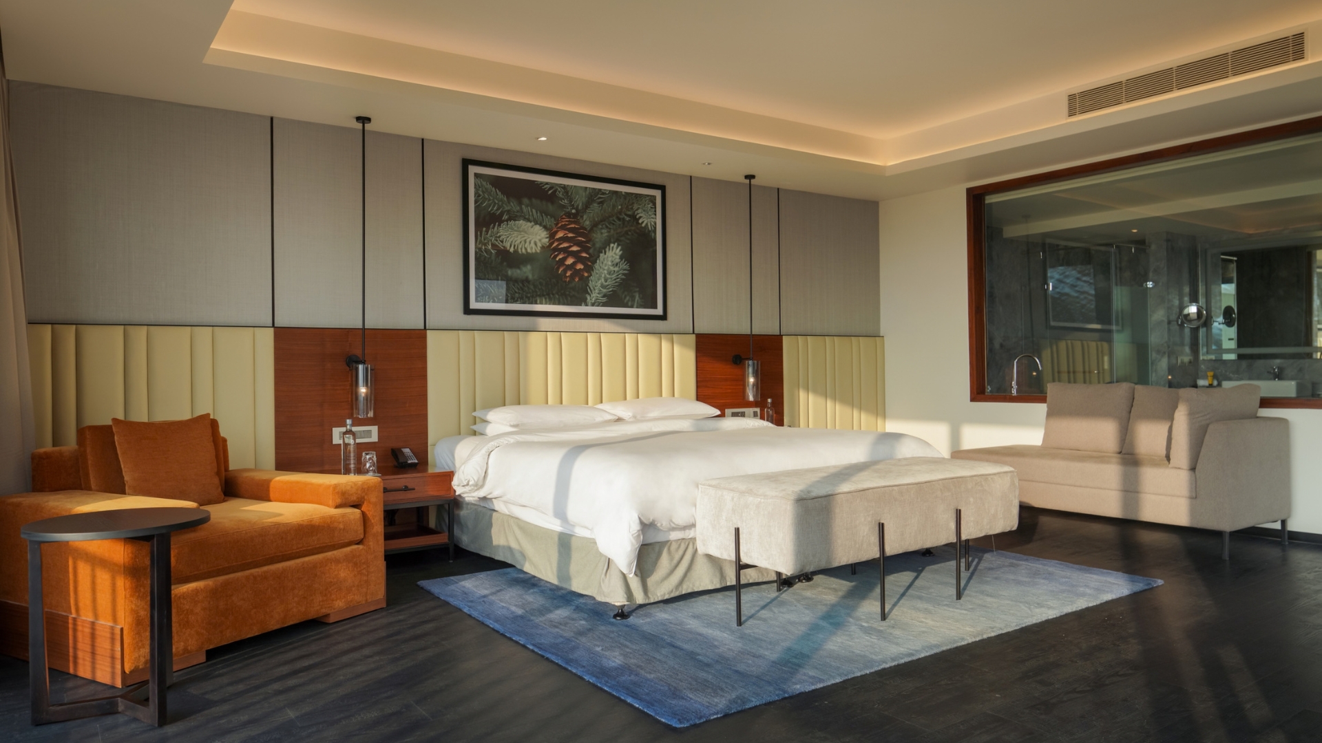 A king-sized bed with tasteful furniture and decorative pieces around it
