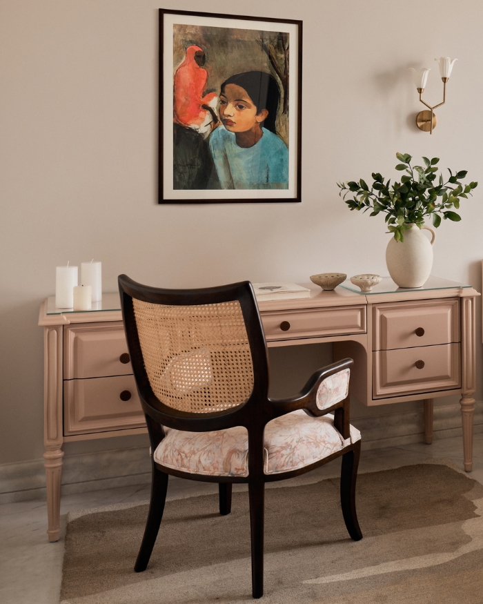 Blush tones soften the daughter's bedroom, where an antique bed refinished in PU meets a custom desk by Ochre At Home, a caned chair and a Klove mushroom lamp. Styled by Kunnal Das; Photography by Gokull Rao Kadam