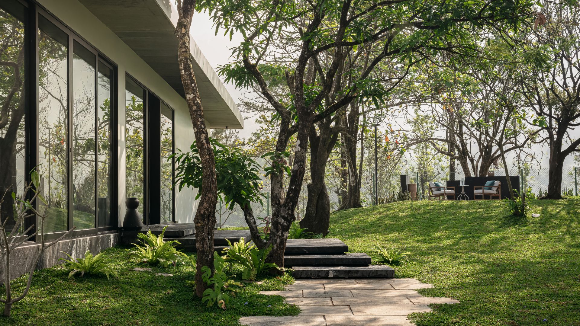 Stepped pathways follow the natural terrain, weaving between existing trees and plants around the home