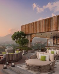 Love seats near the pool with a pool-side bar