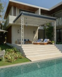 Reflecting the calm of the pool, the outdoor deck features splashes of blue; Photography by Janvi Thakkar