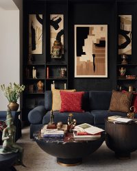 The living room is a maximalist space full of silks, heritage wallpapers,
vintage finds, and gilded accents; Photography by The Matter Studio